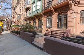 Brooklyn apartment for rent - a brown building with a sidewalk in front of it