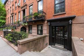 Brooklyn apartment for rent - the front of a brick building with a black door