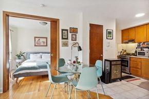 Brooklyn apartment for rent - a bedroom with a bed and a dining room with a table and chairs