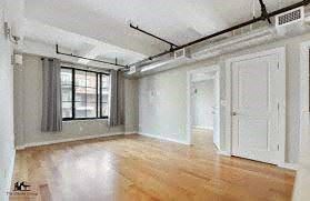 Brooklyn apartment for rent - an empty living room with white walls and wood floors