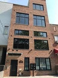 Brooklyn apartment for rent - a tall brick building with lots of windows
