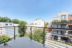 Brooklyn apartment for rent - a balcony with a fence and a view of the city
