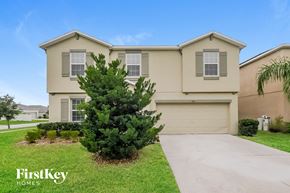Riverview house for rent - A house with a garage and a tree in front of it.