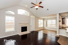 Richmond house for rent - A spacious living room with a fireplace and a ceiling fan.
