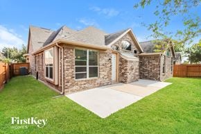 Richmond house for rent - A house with a brown brick exterior and a large front yard.