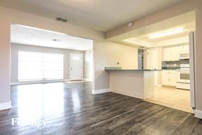 Rotonda West house for rent - an empty kitchen and living room with wood floors and a counter