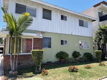 Van Nuys apartment for rent - a white house with a palm tree in front of it