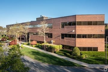 Edison apartment for rent - A modern building with a curved facade and large windows.