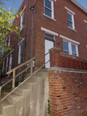 Cincinnati apartment for rent - A red brick building with a white door and windows.