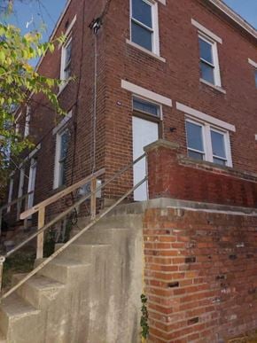 Cincinnati apartment for rent - A red brick building with a white door and windows.