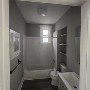 Cincinnati apartment for rent - A small bathroom with a toilet, sink and bathtub.