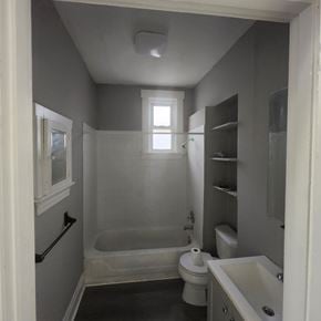 Cincinnati apartment for rent - A small bathroom with a toilet, sink and bathtub.