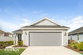 Jacksonville house for rent - a white garage door in front of a house