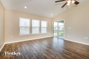 Jacksonville house for rent - the spacious living room with hardwood flooring and a ceiling fan