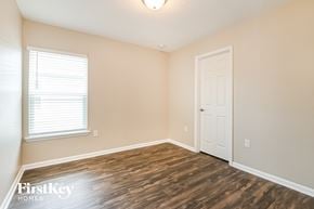 Jacksonville house for rent - a bedroom with a white door and wood flooring