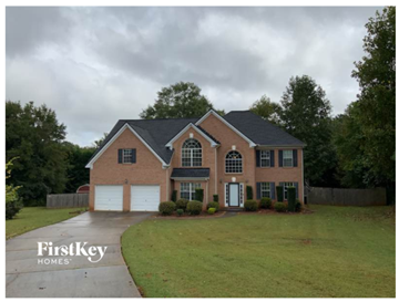 Mcdonough house for rent - A brick house with a black roof and a white garage door.