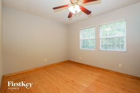 Douglasville house for rent - a bedroom with wood floors and a ceiling fan