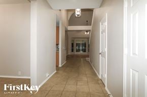 Humble house for rent - A long hallway with a FirstKey Homes logo on the bottom left.