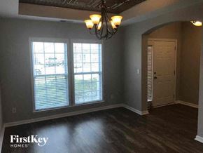 Goose Creek house for rent - a empty living room with a large window and a door