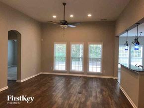 Goose Creek house for rent - an empty living room with a ceiling fan and windows