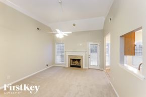 Helena house for rent - A spacious living room with a fireplace and sliding glass doors.