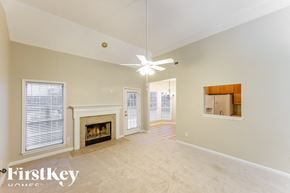 Helena house for rent - A spacious room with a fireplace and a ceiling fan.