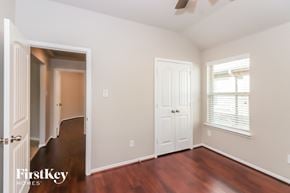 Katy house for rent - a bedroom with wood floors and a door and a closet