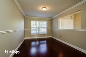 Cape Coral house for rent - a empty dining room with hardwood floors and a window