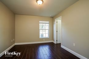 Cape Coral house for rent - the living room of a house with wooden floors and a window