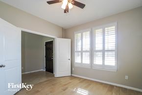 Spring house for rent - a living room with a ceiling fan and windows