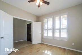 Spring house for rent - an empty living room with a ceiling fan and windows