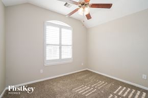 Spring house for rent - the master bedroom has a ceiling fan and a carpet