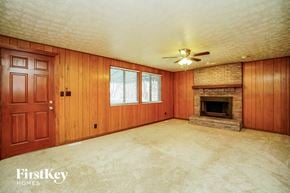 Dublin house for rent - a living room with a fireplace and a ceiling fan
