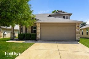 New Braunfels house for rent - A house with a garage and a driveway in front of it.