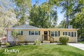 Kennesaw house for rent - A house with a porch and a tree in front of it.
