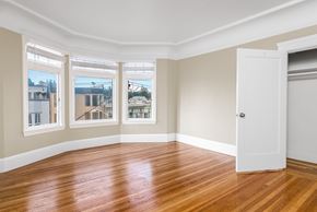 San Francisco apartment for rent - A room with a wooden floor and a white door.