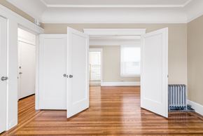 San Francisco apartment for rent - A room with white doors and wooden floors.