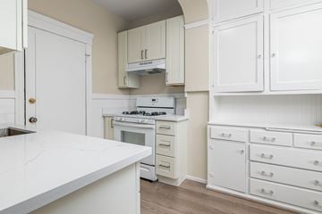 San Francisco apartment for rent - A kitchen with white cabinets and a white countertop.