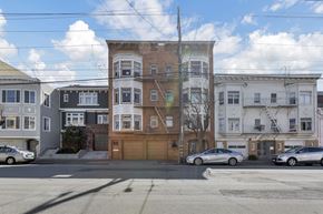 San Francisco apartment for rent - A street view of a residential area with cars parked on the side of the road.