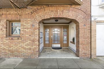 San Francisco apartment for rent - A brick building with a white door and a window above it.