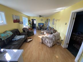 Snowden house for rent - a living room with yellow walls and a wood floor