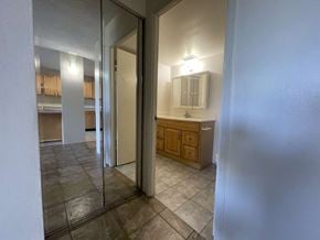Wahiawa apartment for rent - A bathroom with a mirror and a cabinet is visible through a glass door.