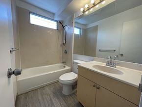 Honolulu apartment for rent - A bathroom with a toilet, sink, and bathtub.