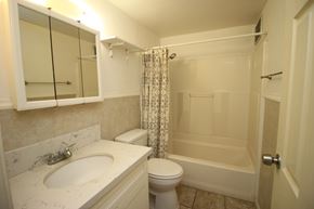 Waianae apartment for rent - A white bathroom with a sink, toilet, and bathtub.