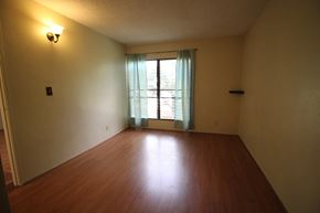 Waianae apartment for rent - A room with a window and a wooden floor.
