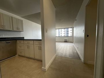 Honolulu apartment for rent - A kitchen with beige cabinets and a tiled backsplash.