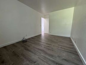 Waianae apartment for rent - A room with wooden flooring and white walls.