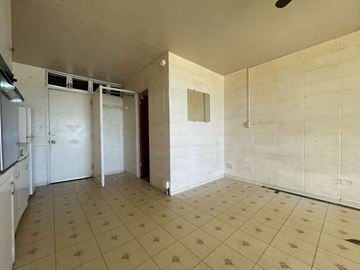 Waianae apartment for rent - A kitchen area with white cabinets and a tiled floor.