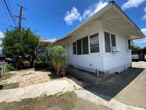 Honolulu apartment for rent - A white house with a brick walkway in front.