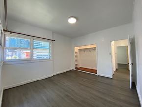 Honolulu apartment for rent - A spacious room with a grey floor and white walls.